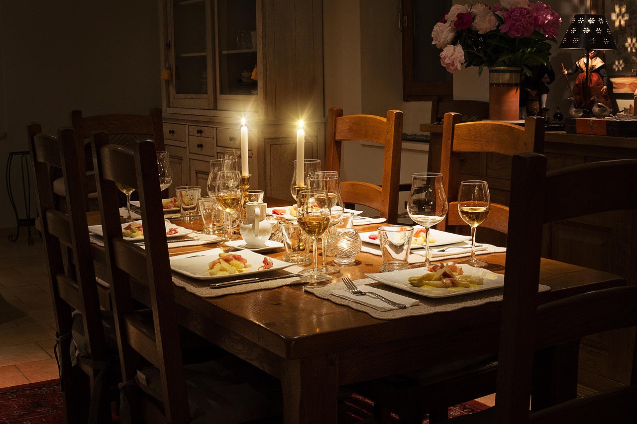 A warmly lit dinner table set for guests